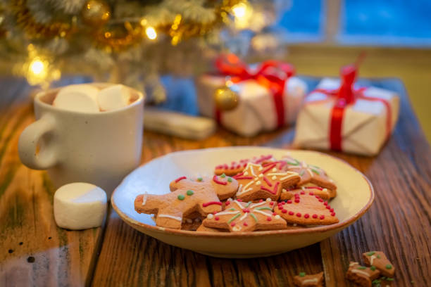 istock Gifts and gingerbread cookies under Christmas tree with lights 1426862040