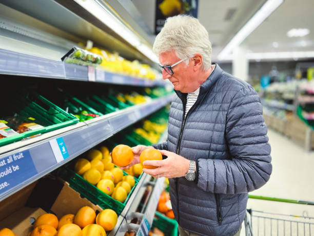 istock Senior man looking at citrus fruit in supermarket 1426862048