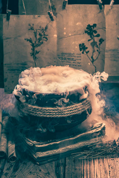 istock Weird witcher cauldron with dried plant cards, Halloween background 1426862080