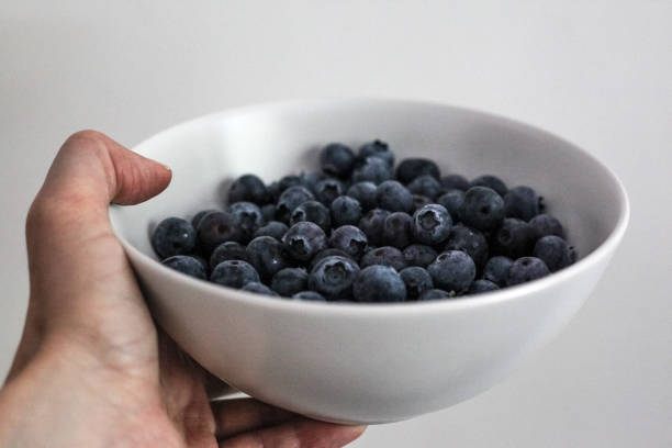 istock Hand holds a bowl of blueberry 1426862800