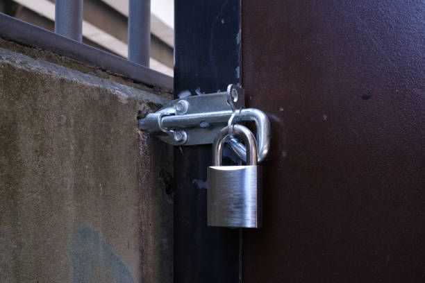 istock Close up of a padlock and a locked door. 1426863587