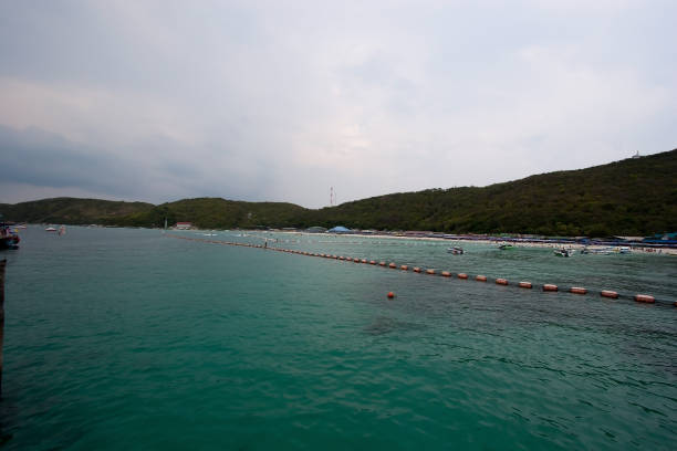 Pattaya (Thai: พัทยา, RTGS: Phatthaya, pronounced [pʰát.tʰā.jāː] (listen)) is a city in Thailand. It is on the east coast of the Gulf of Thailand, about 100 kilometres (62 mi) southeast of Bangkok, within, but not part of, Bang Lamung district in the province of Chonburi. Pattaya City (Thai: เมืองพัทยา, RTGS: Mueang Phatthaya) is a self-governing municipal area which covers Tambon's Nong Prue and Na Klua and parts of Huai Yai and Nong Pla Lai. The city is in the industrial Eastern Seaboard zone, along with Si Racha, Laem Chabang, and Chonburi. Pattaya is at the center of the Pattaya-Chonburi Metropolitan Area—a conurbation in Chonburi Province—with a population of roughly 1,000,000.