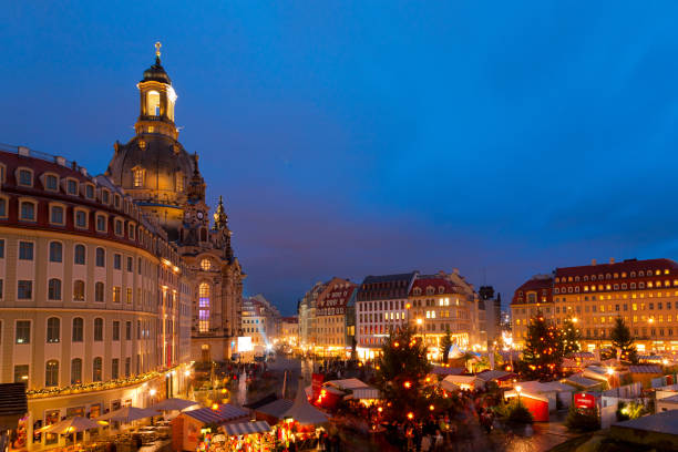 Dresden, Germany - December 6, 2017: Christmas market at Neumarkt square close to Frauenkirche (Church of Our Lady) in dusk. The church was built in 1726-1743, ruined by bombs in 1945, and reconstructed in 1993-2005.