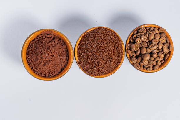 istock three small saucers with coffee beans, ground coffee and cocoa on a white background. 1426875216