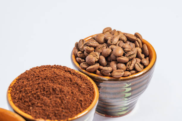 istock Cups with roasted coffee beans and ground coffee, white background and copy space. 1426875565