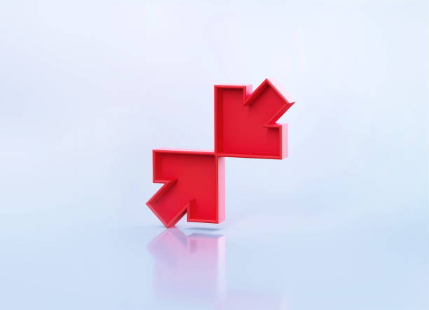 Red conflicting arrow symbols sitting over grey reflective background. Horizontal composition with copy space.