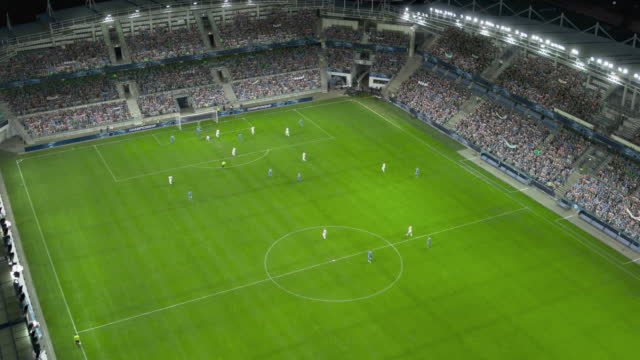 Aerial Establishing Shot of a Whole Stadium with Soccer Championship Match. Teams Play, Crowds of Fans Cheer. Football Tournament, Cup Broadcast. Sport Channel Television Playback, Screen Content