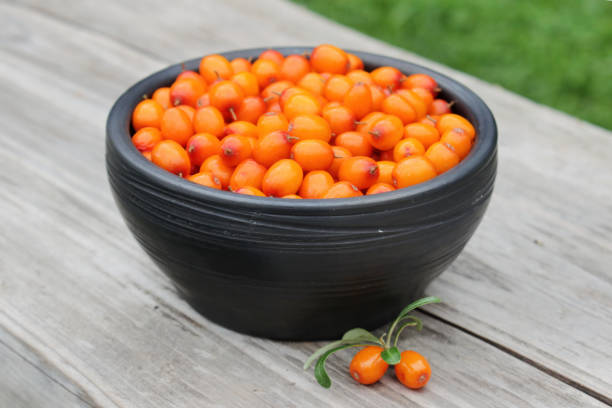 istock Ripe sea buckthorn berries in black ceramic bowl 1426888706