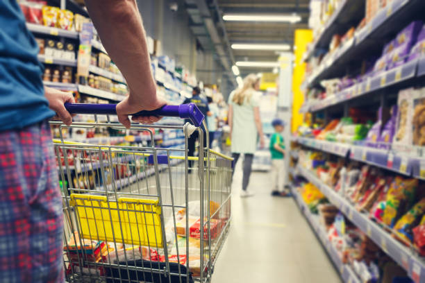 istock Man with a basket walks in a supermarket. 1426888998
