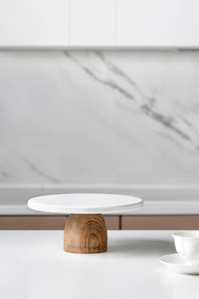 istock White empty Cake stand, Bakery utensil. Podium for cake. Minimalist mock up for cake with kitchen interior. 1426889729