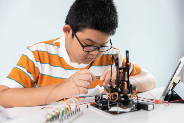 istock Children creating robot cars using a digital tablet at home 1426891459