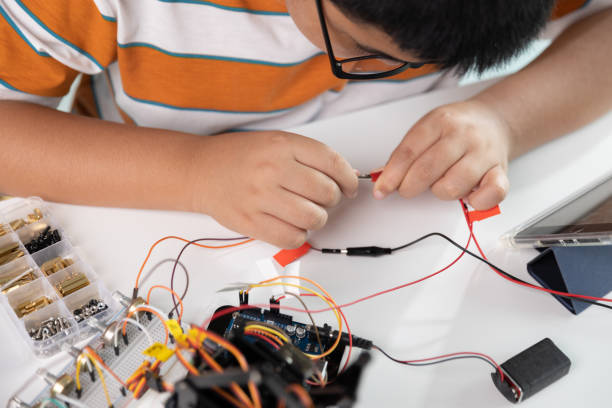 istock Children creating robot cars using a digital tablet at home 1426891483