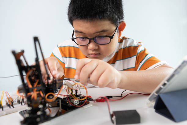 istock Children creating robot cars using a digital tablet at home 1426891509