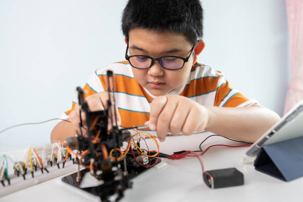 istock Children creating robot cars using a digital tablet at home 1426891511