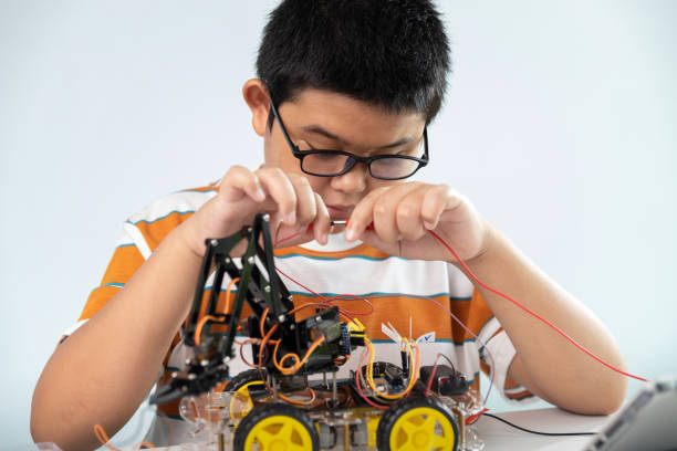 istock Children creating robot car cars using a digital tablet at home 1426891557