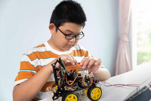 istock Children creating robot car cars using a digital tablet at home 1426891586