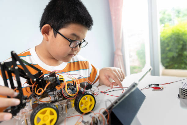 istock Children creating robot car cars using a digital tablet at home 1426891609