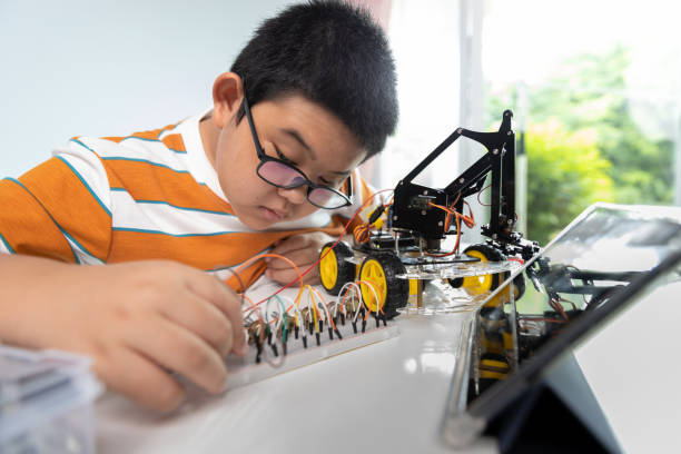 istock Children creating robot car cars using a digital tablet at home 1426891651