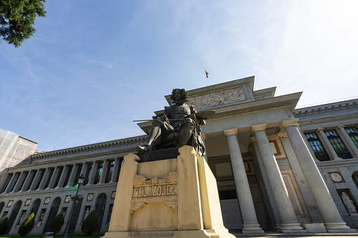 Madrid, Spain, September 2022.  the Velazquez Statue in front of the Prado Museum building in the city center