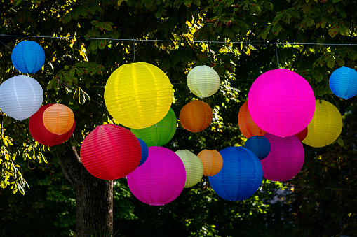 Party with colourful lampions hanging in the garden