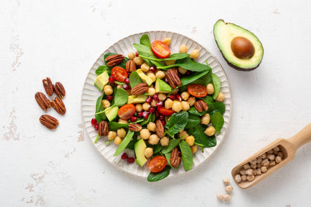 Vegan salad with chick-pea avocado spinach top view healthy food stock photo