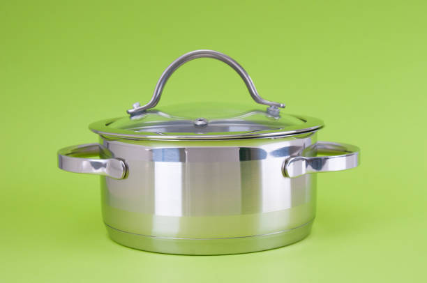 istock Stainless saucepan with glass lid  on a green background 1426899980