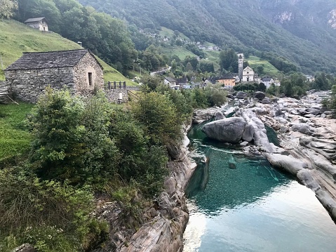 River in Valley Verzasca and Bridge Ponti dei Salti with Mountain in a Sunny Day in Ticino, Switzerland.