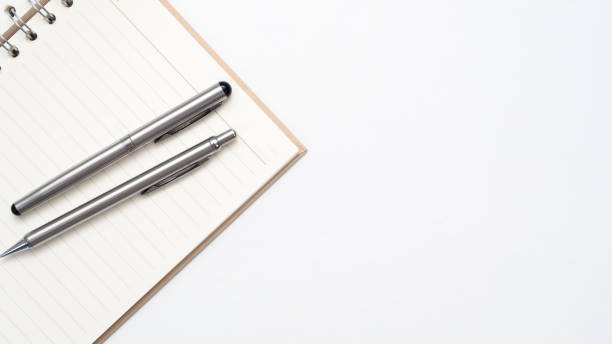 istock Close up silver pen on blank page diary top view copy space 1426904379