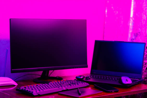 istock Workplace of a graphic designer and creative retoucher. Graphic tablet, smartphone and computer equipment in neon light. Workspace of creative designer with tablet and stylus 1426905875