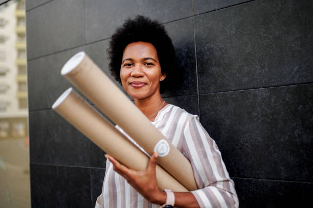 istock Portrait of architect black woman holding projects 1426911010