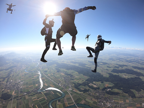 Skydivers fall upside down, in aerial flight