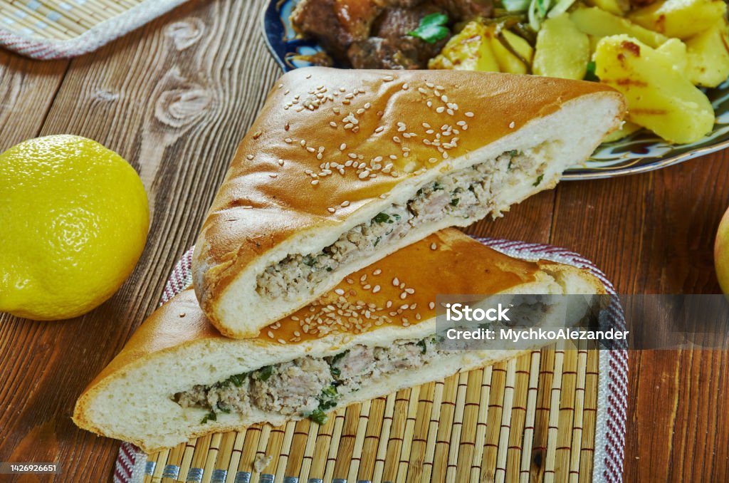 Caucasian  Ossetian Meat Pie Ossetian Meat Pie, Caucasian  cuisine, Traditional assorted dishes, Top view. Chechnya Stock Photo