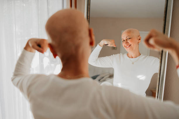 A woman, a cancer fighter and a mirror stock photo