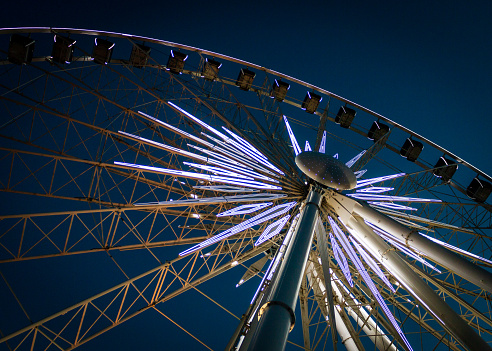 An illuminated ferris wheel at night