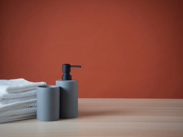 istock Clean towels and Soap dispenser on wooden table. 1426934941