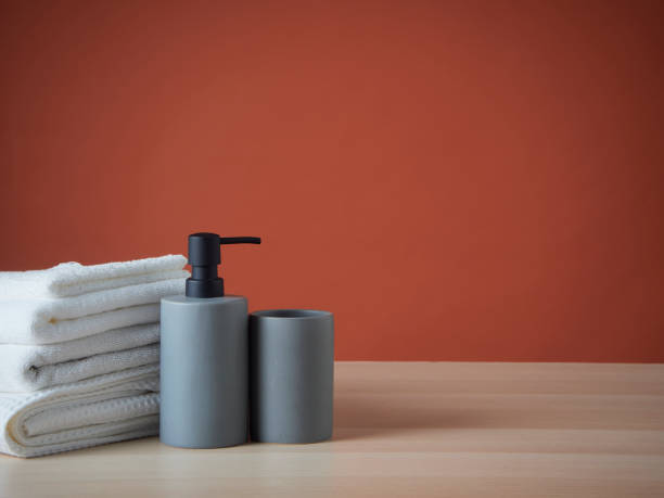 istock Clean towels and Soap dispenser on wooden table. 1426934951