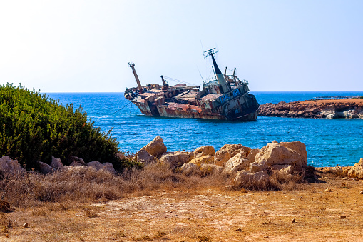 A giant ship, 'The Edro III', sits washed up on shore and has been there for many years, rusting and being engulfed by nature. Now a tourist hotspot and landmark for all to see.