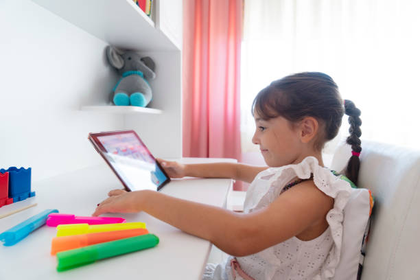 istock Cute Girl sitting at home and studying over internet 1426936672