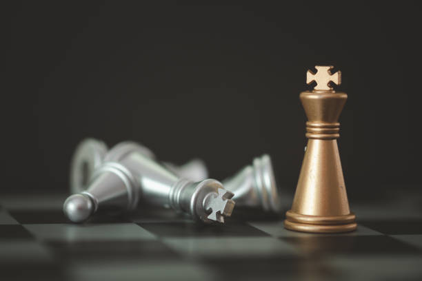 istock Golden knight stand as last winner over silver chess on chess board. 1426938112