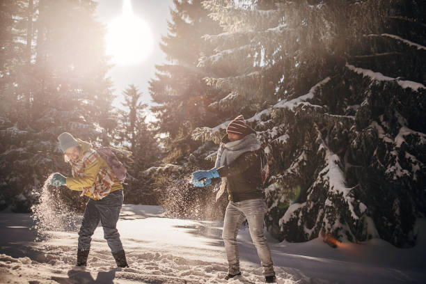 istock Father and daughter having fun with snow 1426941786
