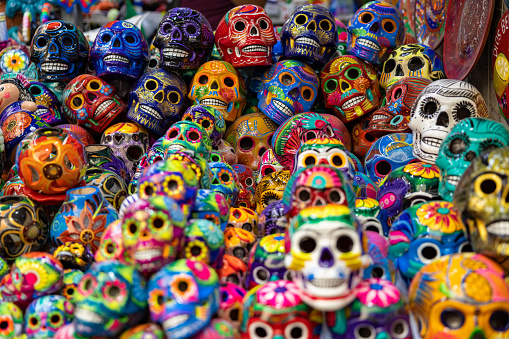 Dozens of colorfully painted skulls presented as typical Mexican souvenirs