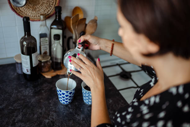 Beautiful woman pouring morning coffee in to cup stock photo