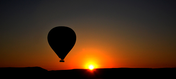 tourist balloons for flying in the early dawn with the sunrise on the horizon