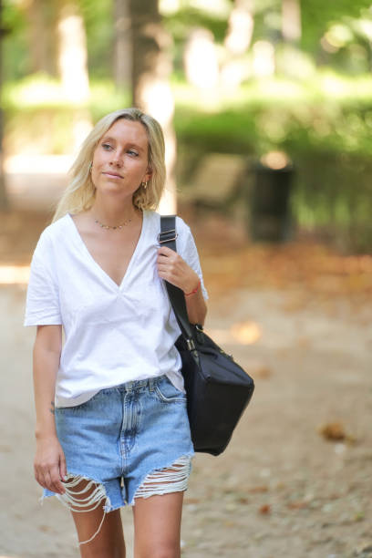istock Young woman walking outdoors in a park. 1426948806