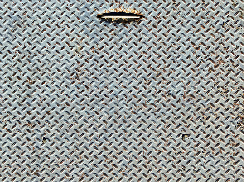 a rusted diamond plate steel door lid iron ridged ship floor trapdoor hatch metal rusty industrial background old industry rust handle backdrop