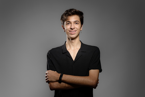 Photo of teenage student in studio with gray background
