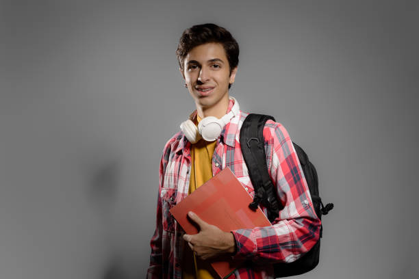 Photo of teenage student in studio with gray background
