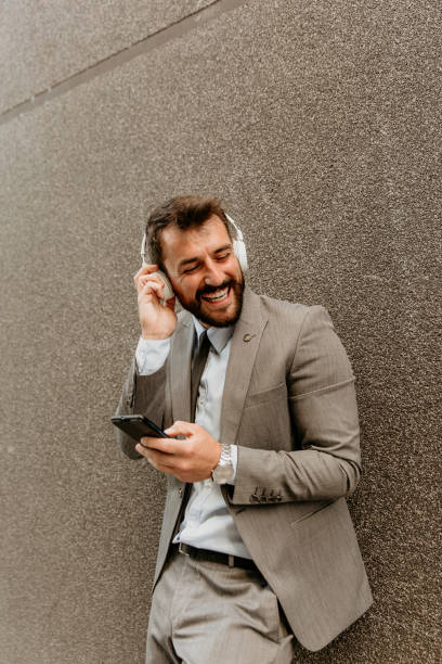 istock Handsome businessman enjoying some music on break 1426955591