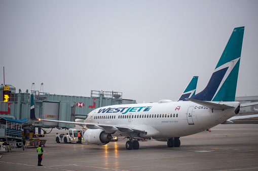 WestJet Boeing 737-7CT aircraft with registration C-GWSO parked at Gate B14 at Toronto Pearson International Airport in April 2022.