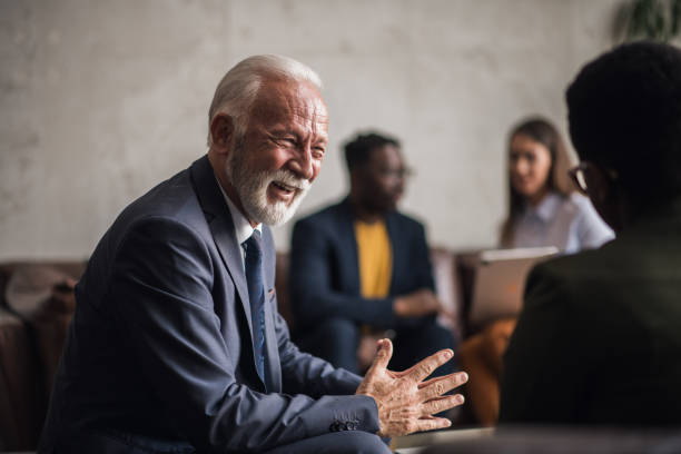istock Senior businessman talking to his colleagues 1426960227